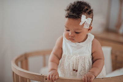 Cute baby girl sitting at home