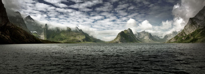 Panoramic view of sea and mountains against sky