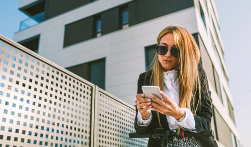 Full length of woman using mobile phone