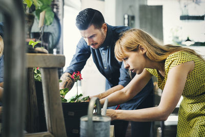 Male and female owners working together in plant shop