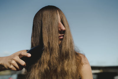 Woman brushing hair