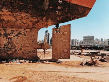 Low angle view of destroyed ship from the beirut port explosion against sky and city skyline