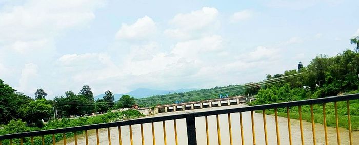 View of bridge against cloudy sky