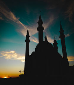 Low angle view of silhouette building against sky during sunset