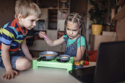 Cheerful kids with food on table