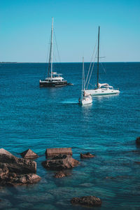 Sailboat sailing on sea against sky