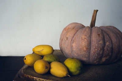 High angle view of pumpkins on table against wall