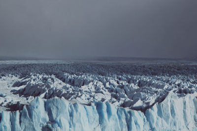 Panoramic view of snowcapped landscape against sky