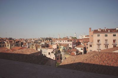 Houses in city against clear sky