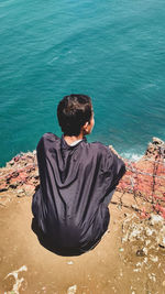 Rear view of man looking at sea