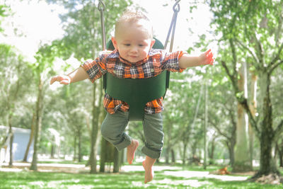 Baby boy in swing at park