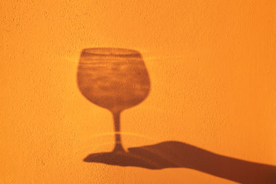 Close-up of trophy against yellow wall