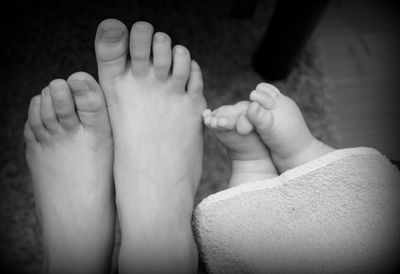 Close-up of baby feet on bed