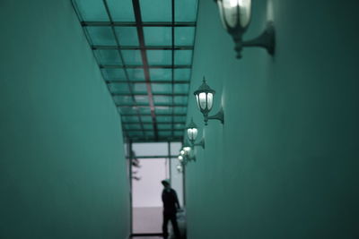 Man walking in illuminated corridor