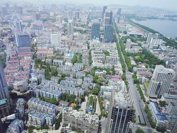 High angle view of modern buildings in city against sky