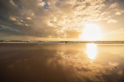 Scenic view of beach against sky during sunset