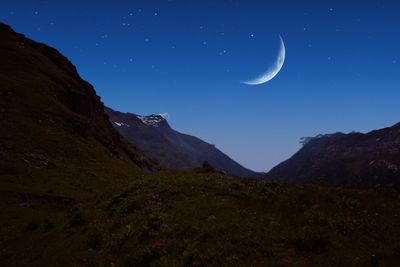 Scenic view of mountains against sky at night