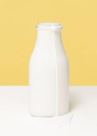 Close-up of milk bottle on table