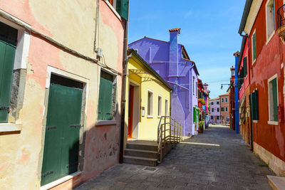 Street amidst buildings against sky