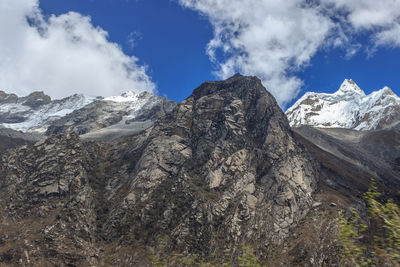 Scenic view of mountains against cloudy sky