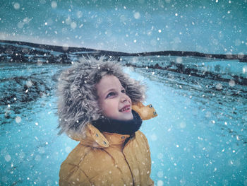 Smiling girl looking up during winter