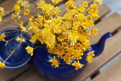 High angle view of yellow flower pot on table
