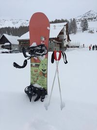 People on snow covered field against mountain