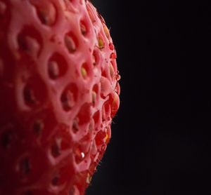 Close-up of strawberry over black background