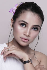 Close-up portrait of a beautiful young woman over white background