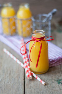 Close-up of orange juice in bottle on table