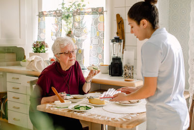 Woman holding ice cream at home