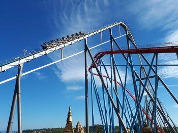 Low angle view of metallic structure against blue sky