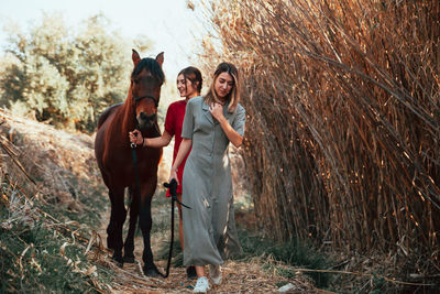 Women with horse in forest