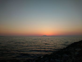 Scenic view of sea against clear sky during sunset