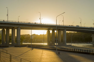 Bridge over river against sky during sunset