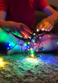 Close-up of hand on illuminated painting