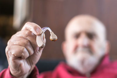 Close-up of woman holding dentures