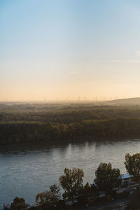 Scenic view of river against sky at sunset
