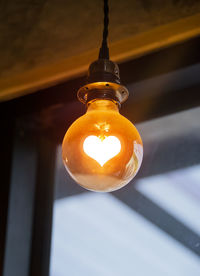 Low angle view of illuminated light bulb