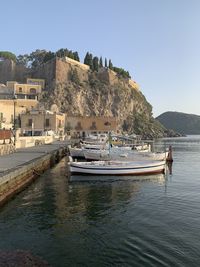 Boats moored on sea against clear sky