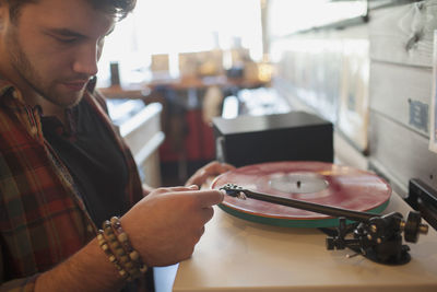 Young man listening to a record.