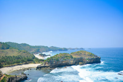 Scenic view of sea against clear blue sky