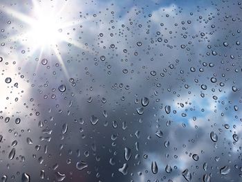 Full frame shot of wet glass window during rainy season