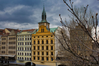 Low angle view of buildings against cloudy sky