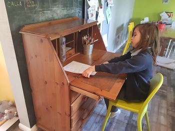 Woman sitting on table in restaurant