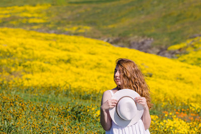 Side view of woman standing on field