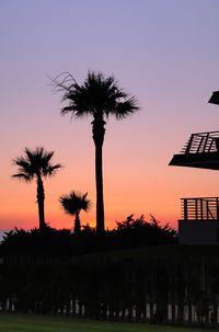 Silhouette palm trees against sky during sunset