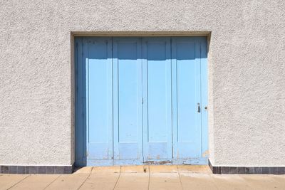 Blue closed door of building.