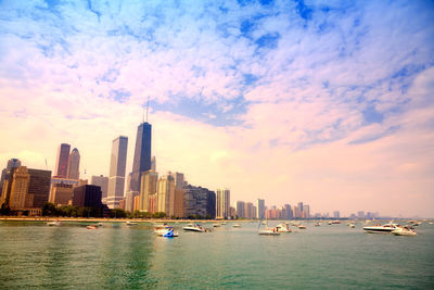 View of buildings in city against cloudy sky