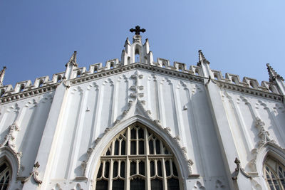 Low angle view of church against blue sky